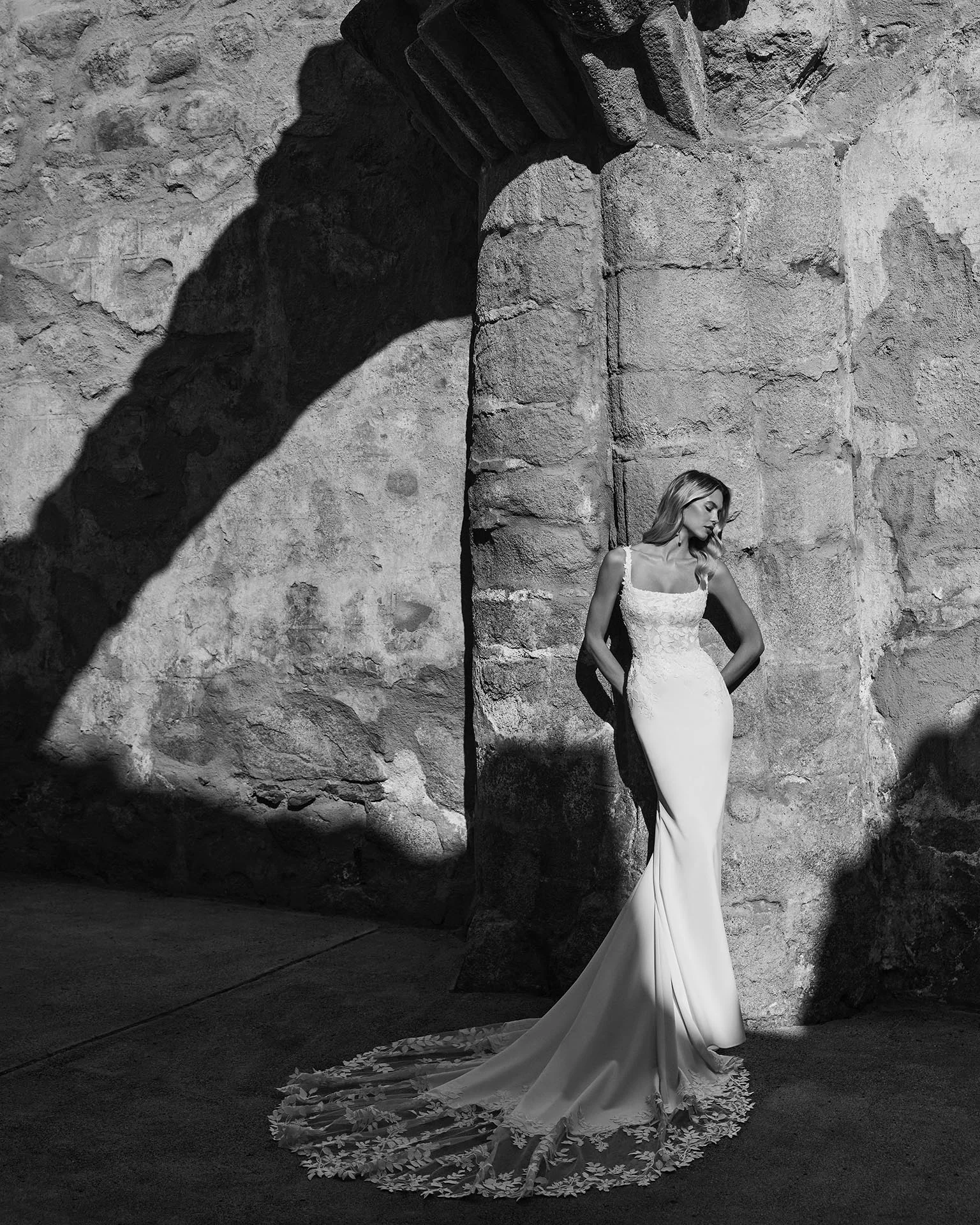 Adriana Alier Paramo 2N13 wedding dress — editorial side view with lace-edged train