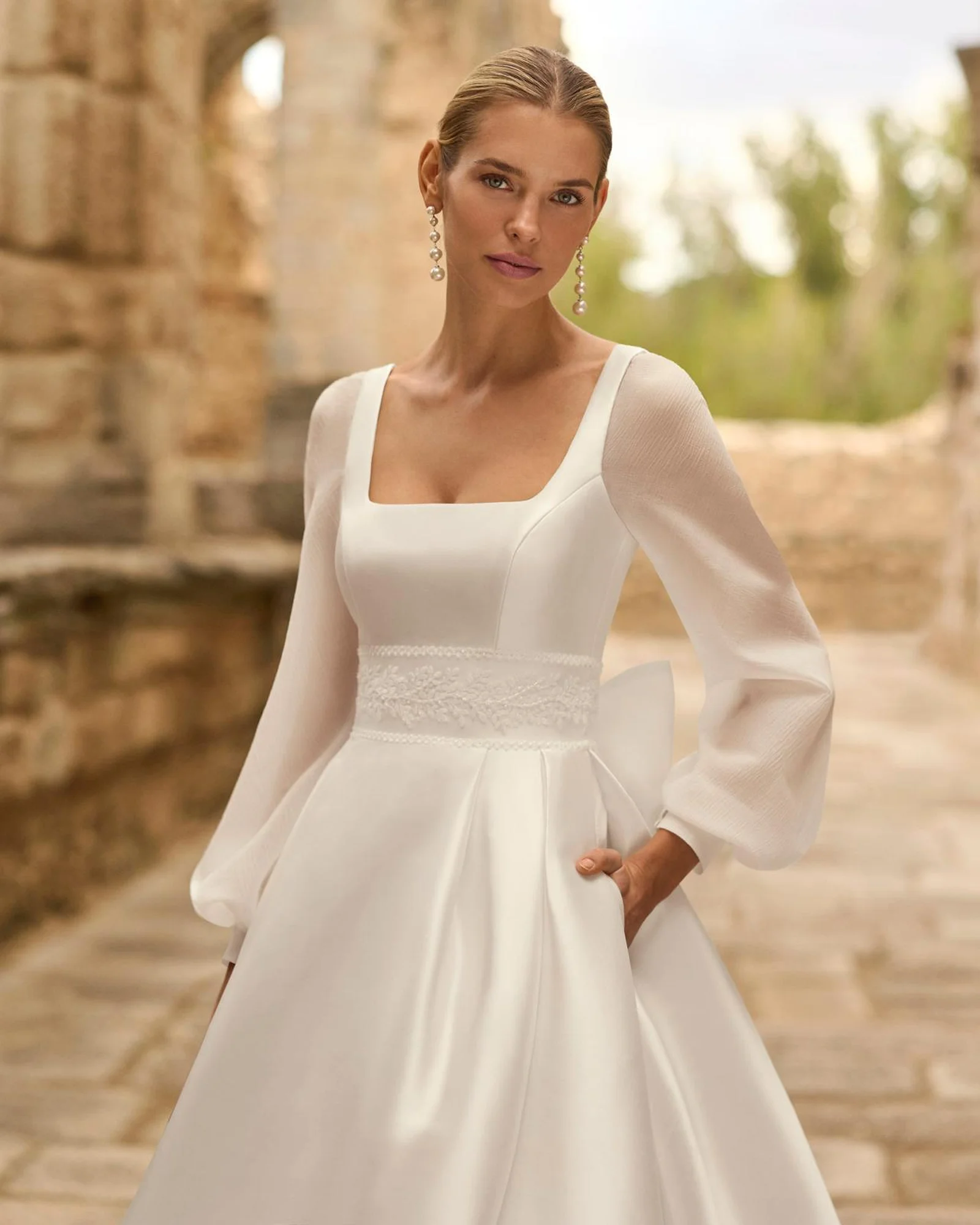 Adriana Alier Porto wedding dress — lace waistband and sheer full-length sleeve detail