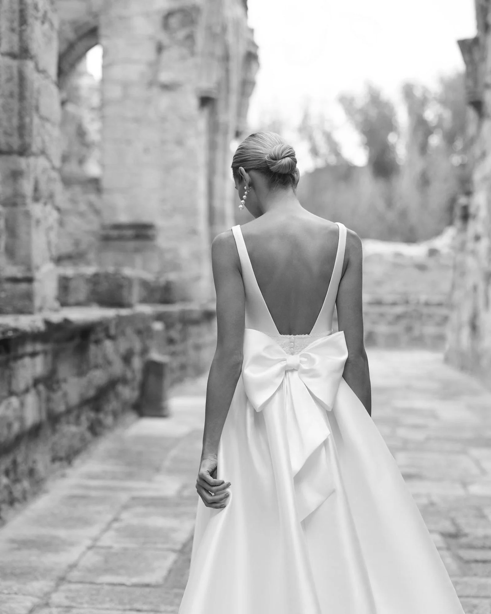 Adriana Alier Porto wedding dress — black and white editorial of the low back and oversized satin bow